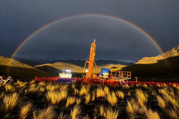 Drill rig under a rainbow, Andean highlands